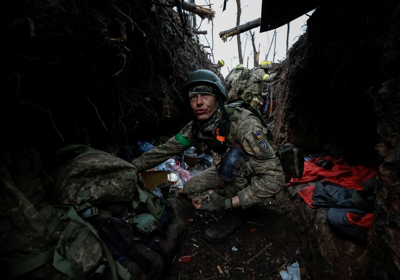 Ukrainian servicemen rest at their positions in a dark, deep trench after a fight, as Russia's attack on Ukraine continues, near Bakhmut, Ukraine on May 11, 2023. Radio Free Europe/Radio Liberty/Serhii Nuzhnenko via REUTERS