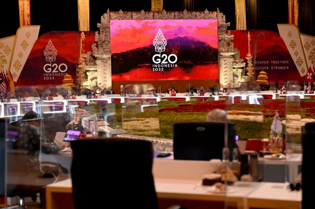 Chairs surround round tables in front of a bright LED screen displaying Indonesian’s G20 theme at a meeting of the G20 finance ministers in Bali, Indonesia on July 16, 2022. 