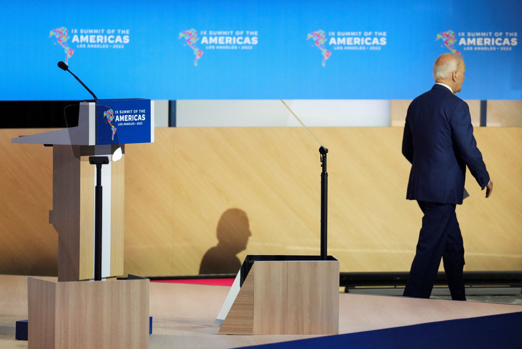 U.S. President Joe Biden walks off the stage with his back to the camera after speaking during the opening plenary session at the Ninth Summit of the Americas in Los Angeles, California on June 9, 2022. 