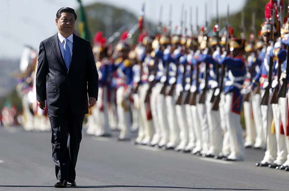 China's President Xi Jinping reviews an honor guard at the sixth BRICS summit in Brasilia on July 17, 2014 (Sergio Moraes/Courtesy Reuters).