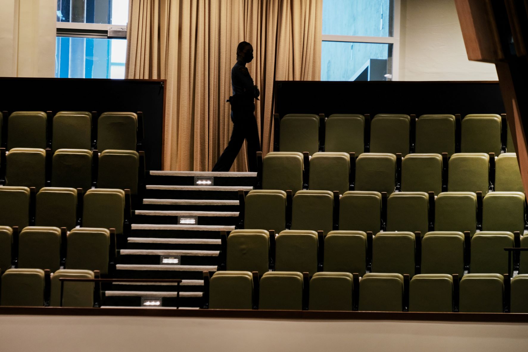 A United Nations security guard walks through an empty hall as COVID-19 restrictions have kept the number of delegates limited at the seventy-sixth session of the United Nations General Assembly in New York on September 23, 2021.