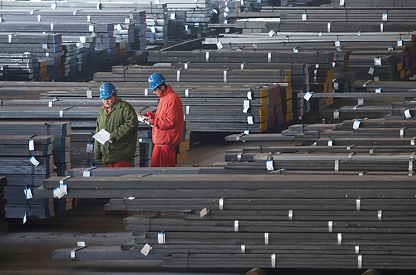 Workers check steel bars at a factory of Dongbei Special Steel Group Co., Ltd. in Dalian, Liaoning province, China November 27, 2017.  REUTERS