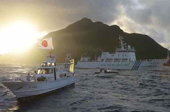 Chinese marine surveillance ship sails near Japan Coast Guard vessels near one of the disputed islands, called Senkaku in Japan and Diaoyu in China (Kyodo/Courtesy Reuters).