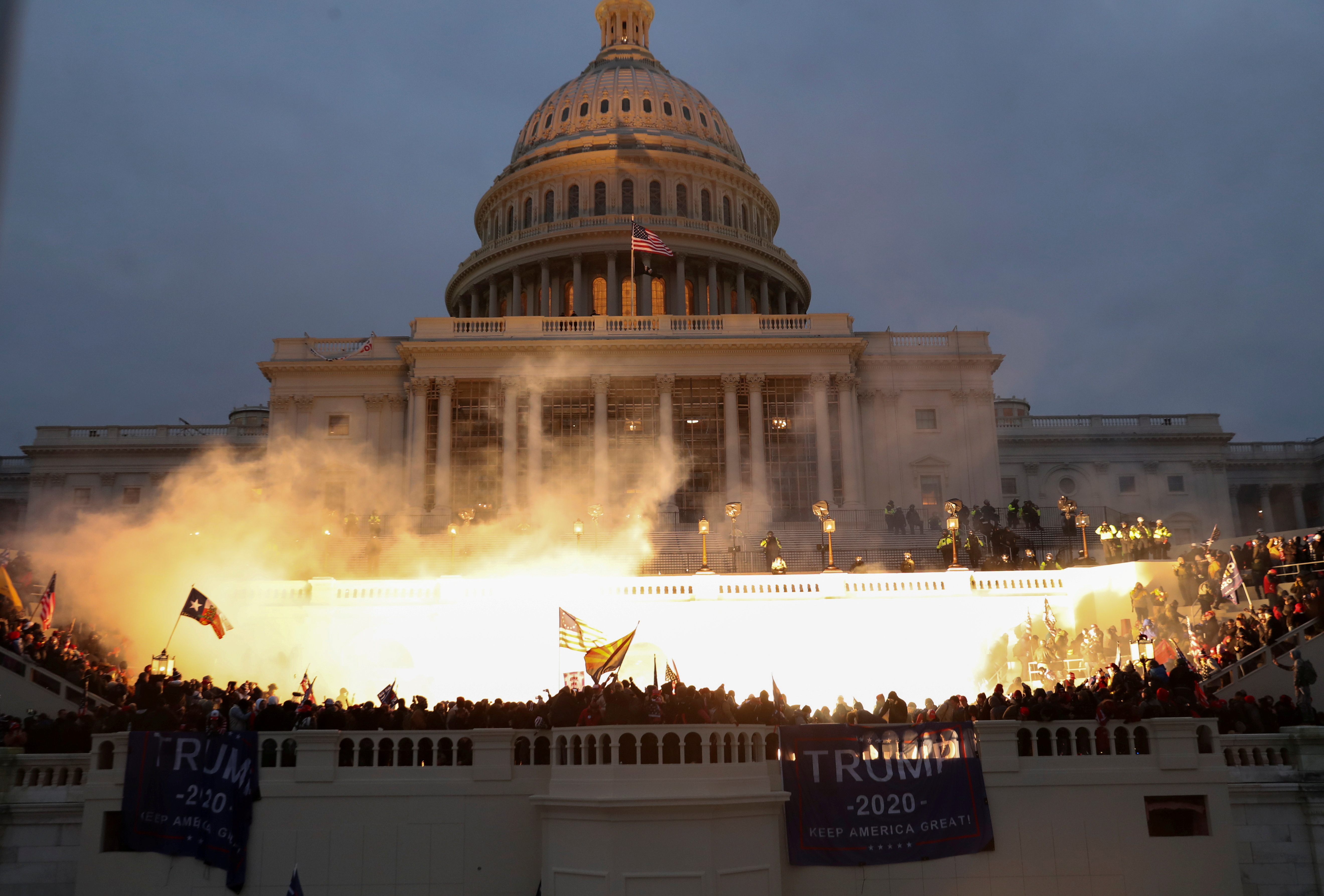 An explosion caused by a police munition is seen while supporters of U.S. President Donald Trump gather in front of the U.S. Capitol Building in Washington, DC, on January 6, 2021.