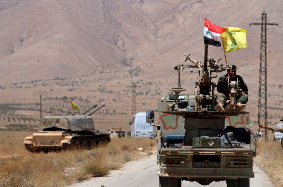 Hezbollah and Syrian flags flutter on a military vehicle in Western Qalamoun, Syria, August 28, 2017. (Omar Sanadiki/Reuters)