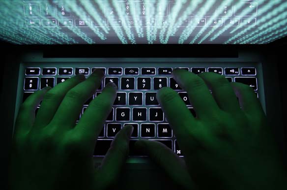 A man types on a computer keyboard in Warsaw, in February 2013 (Kacper Pempel/ Courtesy Reuters).