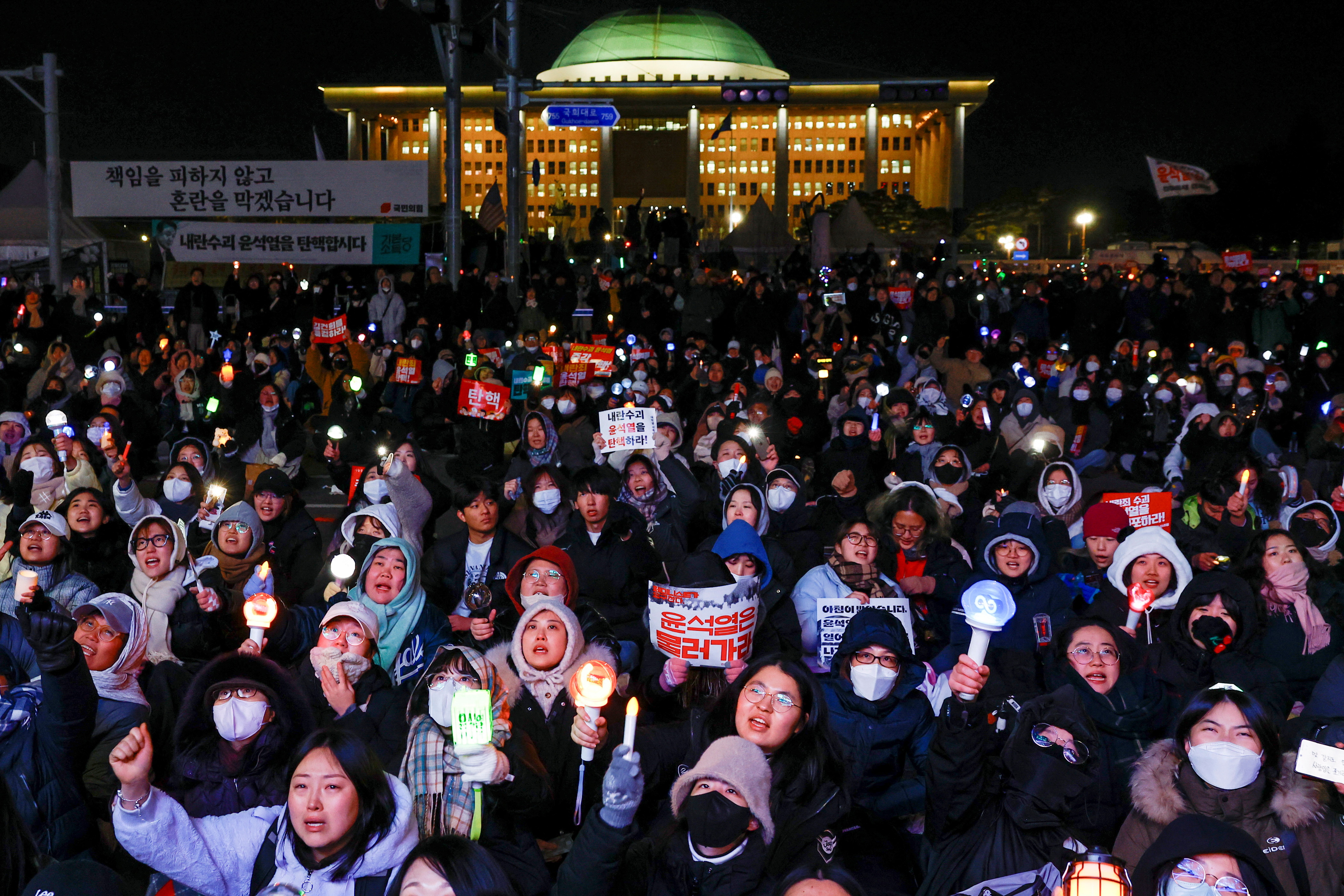 Protesters react after South Korean President Yoon Suk Yeol, who declared martial law which was reversed hours later, survived an impeachment motion, in front of the National Assembly in Seoul, South Korea, December 7, 2024. REUTERS/Kim Kyung-Hoon TPX IMAGES OF THE DAY