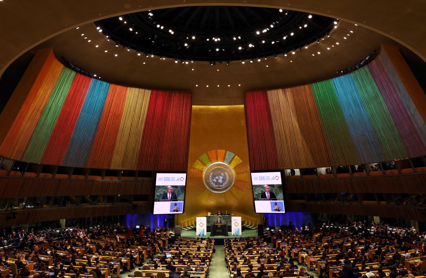 A broad shot of the opening of the Sustainable Development Goals (SDGs) Summit 2023 in New York in the large UN auditorium with colored streamers representing the SDGs hanging around the room on September 18, 2023. REUTERS/Mike Segar