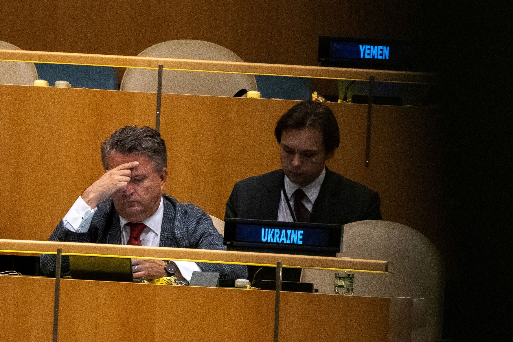 Ukraine's Ambassador to the United Nations Sergiy Kyslytsya sits with his hand on his head gazing downward at the UN General Assembly during the Nuclear Non-Proliferation Treaty review conference in New York City on August 1, 2022