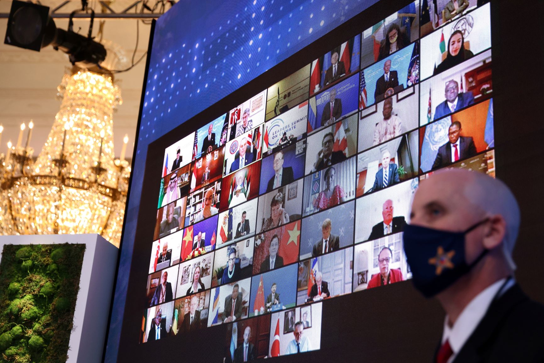 World leaders appear on a video screen during a virtual Climate Summit with world leaders in the East Room at the White House in Washington, DC, on April 23, 2021. REUTERS/Tom Brenner
